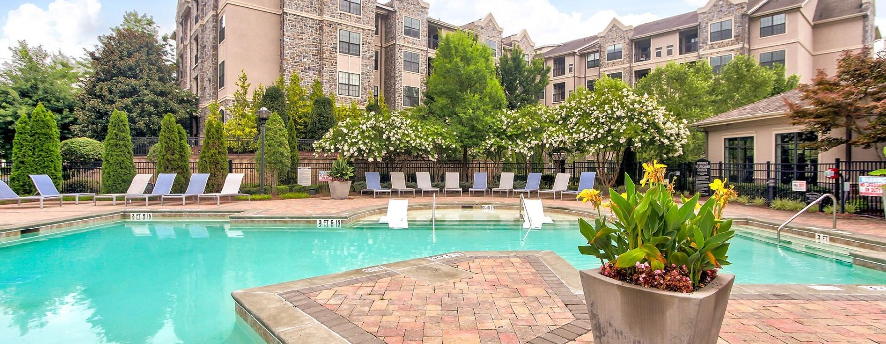 a swimming pool with lush landscaping