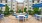 a patio with chairs and tables outside of a building