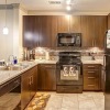 a kitchen with dark wood cabinets