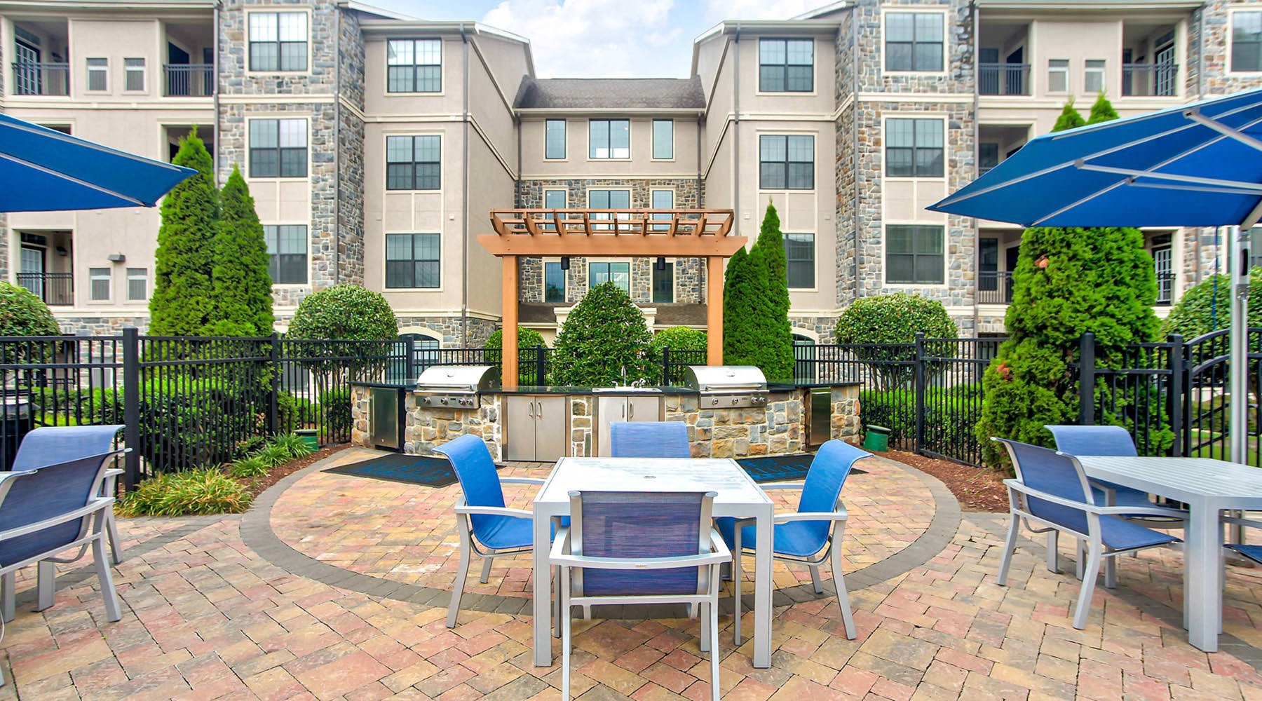 The essence of exceptional living a patio with chairs and tables outside of a building