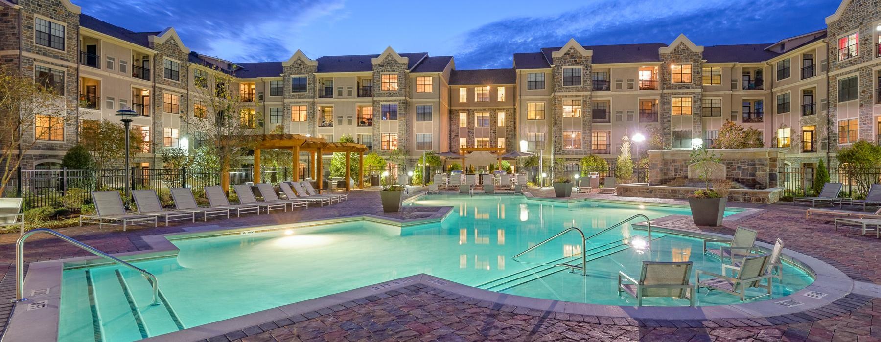 a pool in a courtyard with buildings in the background